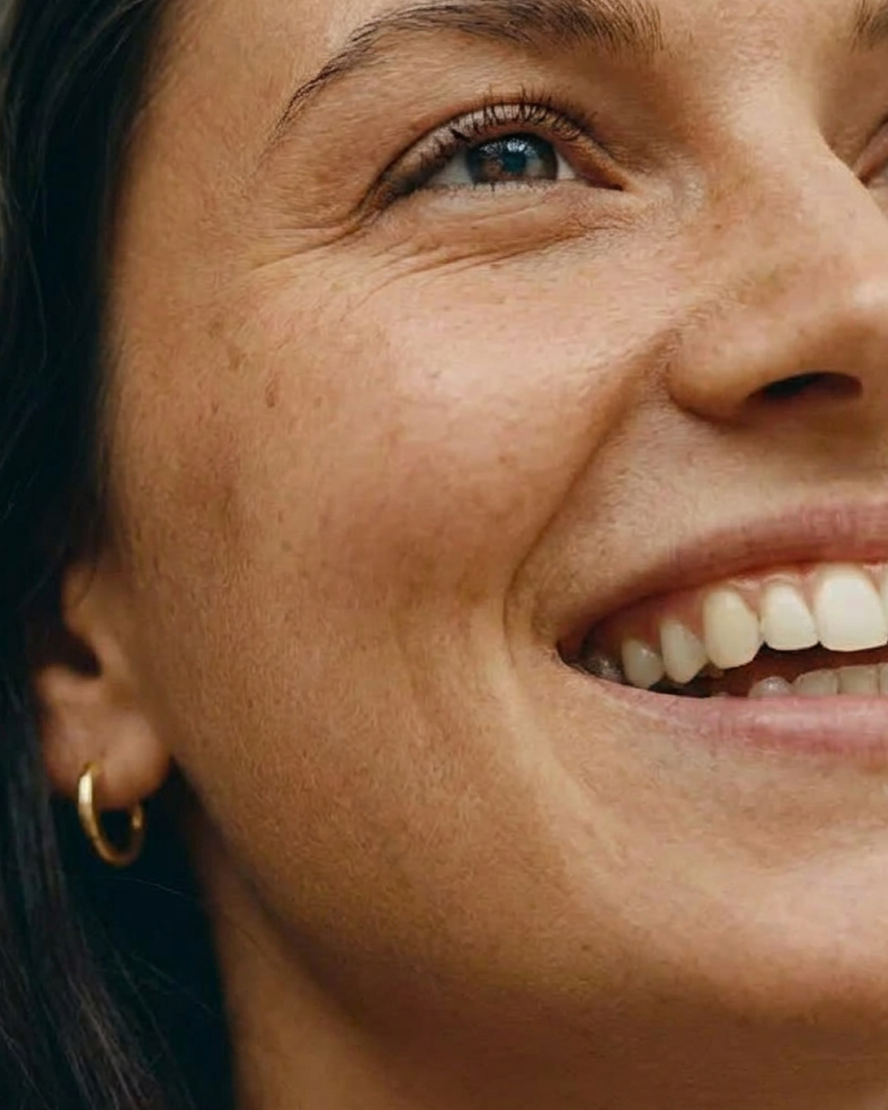 smiling woman gold earring